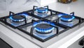 Gas burners with blue flame on modern stove Royalty Free Stock Photo