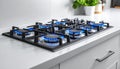 Gas burners with blue flame on modern stove Royalty Free Stock Photo