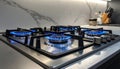 Gas burners with blue flame on modern stove Royalty Free Stock Photo
