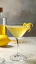 Glass of Lemon Drop Martini cocktail with zest on table against blurred background Royalty Free Stock Photo