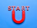 Red magnet with word START on dark blue background, top view Royalty Free Stock Photo