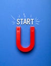 Red magnet with word START on dark blue background, top view Royalty Free Stock Photo