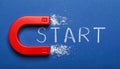 Red magnet with word START on dark blue background, top view Royalty Free Stock Photo