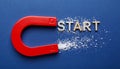 Red magnet with word START on dark blue background, top view Royalty Free Stock Photo