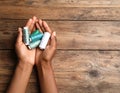 Woman holding clews of threads on wooden background, top view. Space for text Royalty Free Stock Photo