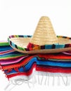 Mexican sombrero hat and colorful poncho isolated on white Royalty Free Stock Photo