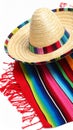 Mexican sombrero hat and colorful poncho isolated on white Royalty Free Stock Photo