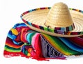Mexican sombrero hat and colorful poncho isolated on white Royalty Free Stock Photo