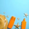 Flat lay composition with sunscreen and beach accessories on light blue background Royalty Free Stock Photo