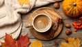 Flat lay composition with cup of hot drink on wooden table. Cozy autumn atmosphere Royalty Free Stock Photo
