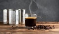 Aromatic coffee in a glass and beans on a wooden table, plain canned food Royalty Free Stock Photo