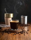 Aromatic coffee in a glass and beans on a wooden table, plain canned food Royalty Free Stock Photo