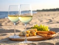 Glasses with white wine and snacks for beach picnic on sandy seashore Royalty Free Stock Photo