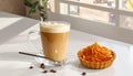 Cup of caramel macchiato and tasty pastry on table Royalty Free Stock Photo