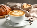 Cup of caramel macchiato and tasty pastry on table Royalty Free Stock Photo