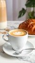 Cup of caramel macchiato and tasty pastry on table Royalty Free Stock Photo