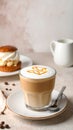 Cup of caramel macchiato and tasty pastry on table Royalty Free Stock Photo