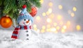 Cute snowman, fire tree branches and balls against fuzzy Christmas lights, bokeh effect Royalty Free Stock Photo