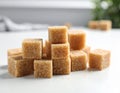 Cubes of brown sugar fill a white ceramic bowl, placed on a white surface. Royalty Free Stock Photo