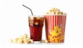 A glass filled with dark soda and ice cubes sits beside a large tub of popcorn. Royalty Free Stock Photo