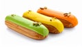 Eclairs with colorful glaze and pistachio toppings. Royalty Free Stock Photo