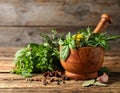 Different aromatic herbs, mortar with pestle and spices on wooden table, closeup Royalty Free Stock Photo