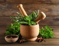Different aromatic herbs, mortar with pestle and spices on wooden table, closeup Royalty Free Stock Photo