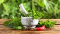 Different aromatic herbs, mortar with pestle and spices on wooden table, closeup Royalty Free Stock Photo