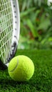 Tennis racket and ball on green artificial turf, close-up. Text area Royalty Free Stock Photo