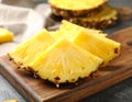 Pieces of tasty ripe pineapple on wooden board, closeup Royalty Free Stock Photo