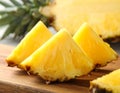 Pieces of tasty ripe pineapple on wooden board, closeup Royalty Free Stock Photo