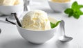 Bowl and spoon with tasty vanilla ice cream on table Royalty Free Stock Photo