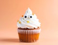 Halloween cupcake with candy ghost eyes on pastel background Royalty Free Stock Photo