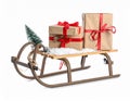 Wooden sleigh with Christmas gift boxes and artificial snow on white background Royalty Free Stock Photo