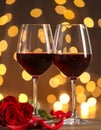 Glasses of red wine against blurred background, closeup. Romantic dinner Royalty Free Stock Photo