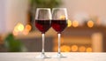 Glasses of red wine against blurred background, closeup. Romantic dinner Royalty Free Stock Photo