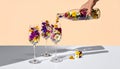 Creative Floral Cocktail Concept with Hand Pouring Flowers Royalty Free Stock Photo