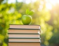 Green apple on a stack of books with nature background Royalty Free Stock Photo