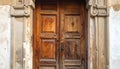 Ancient Wooden Door Surrounded by Weathered Stone Pillars A Timeless Entrance Royalty Free Stock Photo