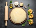 Board with homemade pasta, flour and ingredients on dark table, flat lay Royalty Free Stock Photo