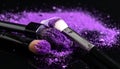 Makeup brushes with purple eye shadow on black background, closeup. Royalty Free Stock Photo