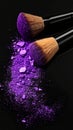 Makeup brushes with purple eye shadow on black background, closeup. Royalty Free Stock Photo