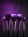 Makeup brushes with purple eye shadow on black background, closeup. Royalty Free Stock Photo