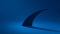 Dark Shark Fin Silhouette Rising from Blue Surface with Distinct Shadow Royalty Free Stock Photo