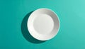 White Ceramic Plate Centered on Teal Background with Shadow Royalty Free Stock Photo