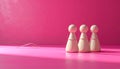 Three Wooden Figurines Round Heads Conical Bodies Vibrant Pink Background White Cord Minimalist Royalty Free Stock Photo