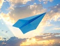 Light blue paper plane flying in sky with clouds with clouds Royalty Free Stock Photo