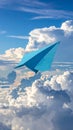Light blue paper plane flying in sky with clouds with clouds Royalty Free Stock Photo