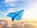 Light blue paper plane flying in sky with clouds with clouds Royalty Free Stock Photo