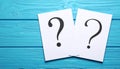 Paper cards with question mark on blue wooden background, top view. Space for text Royalty Free Stock Photo